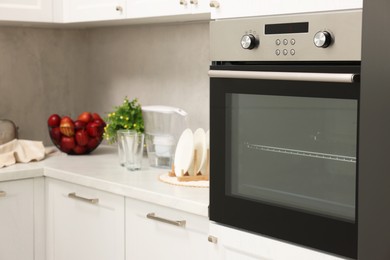 Photo of New electric oven in kitchen. Cooking appliance