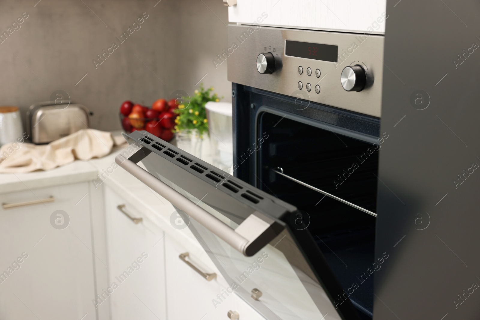 Photo of Open electric oven in kitchen. Cooking appliance