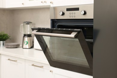 Photo of Open electric oven in kitchen. Cooking appliance