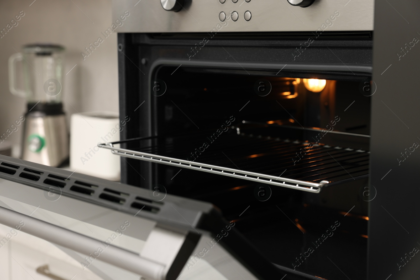 Photo of Open electric oven in kitchen. Cooking appliance