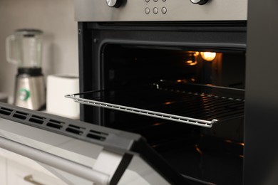 Open electric oven in kitchen. Cooking appliance