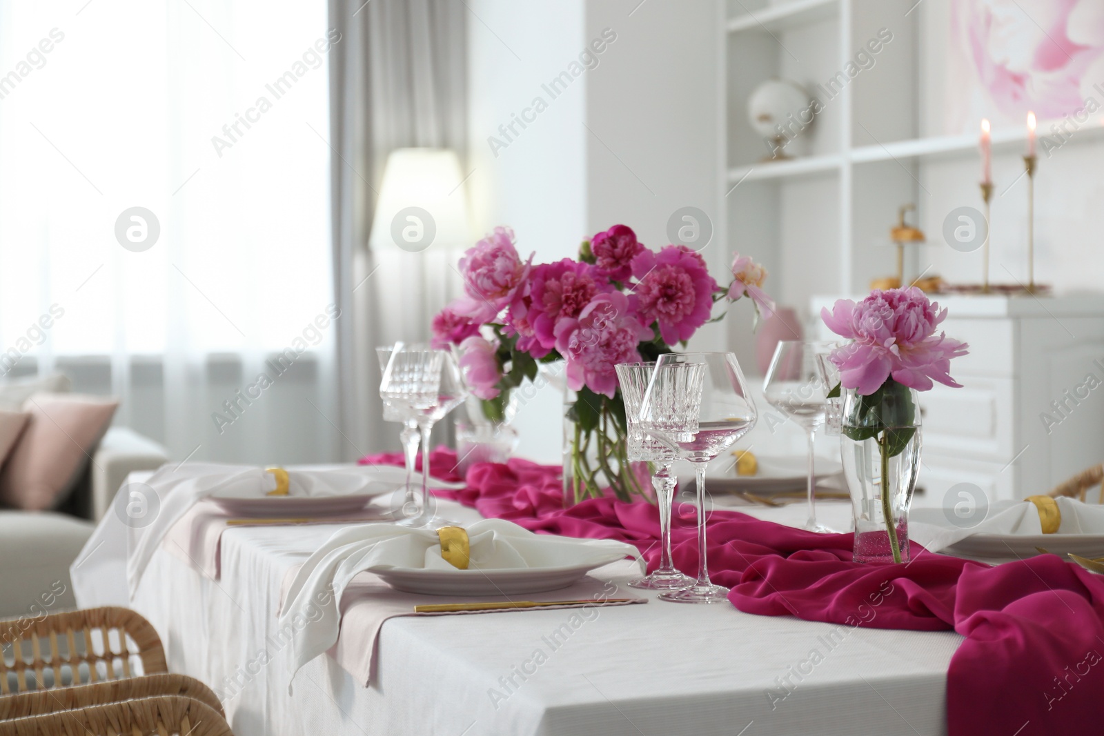 Photo of Beautiful table setting with pink peonies in dining room