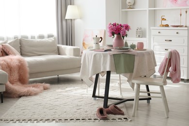 Beautiful table setting with pink peonies in living room