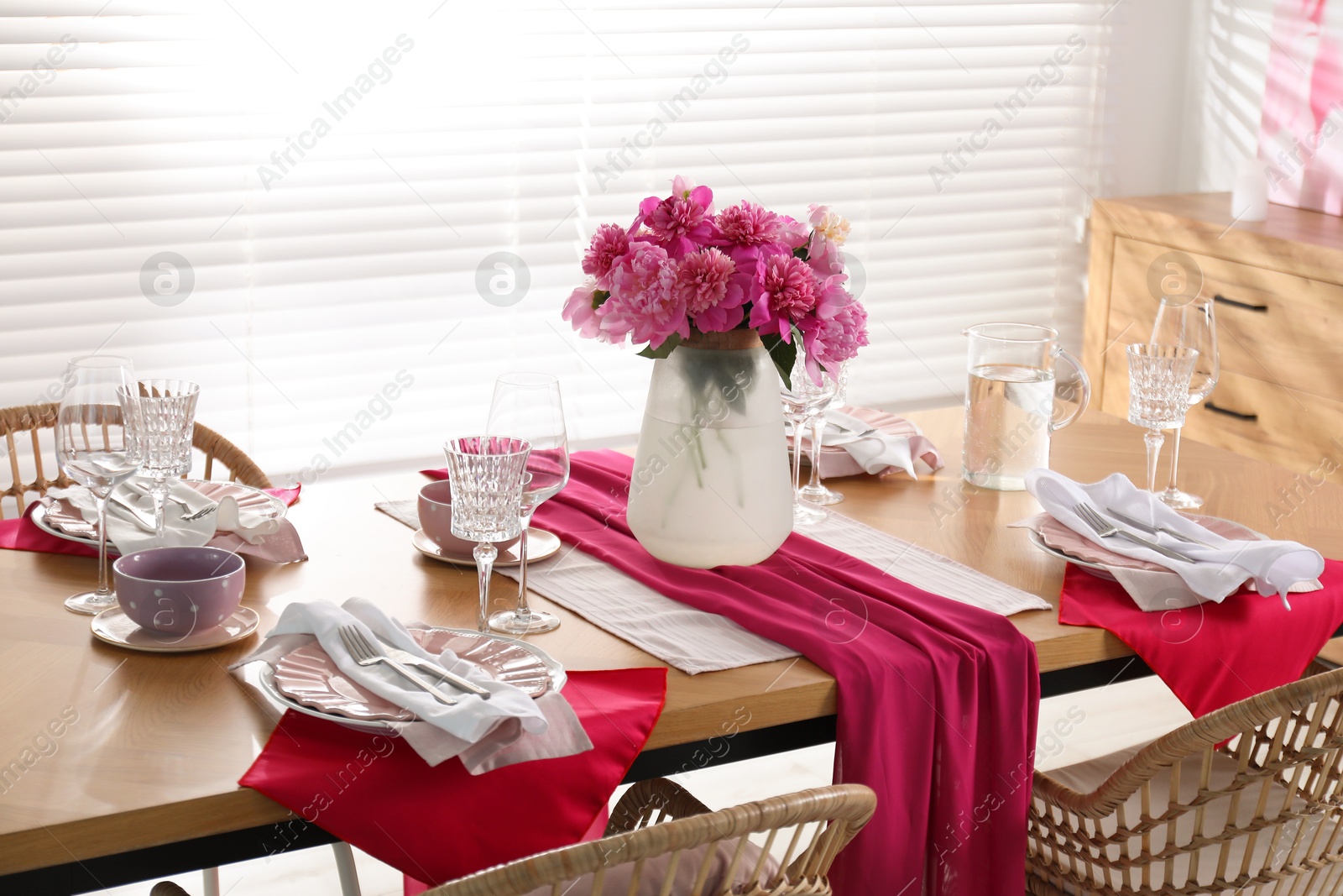 Photo of Beautiful table setting with pink peonies in dining room