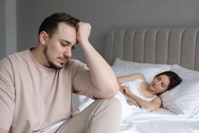 Offended couple after quarrel in bedroom. Relationship problem