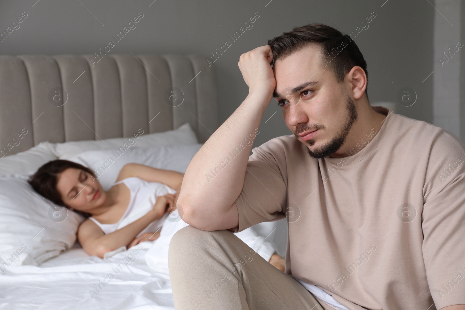 Photo of Offended couple after quarrel in bedroom. Relationship problem