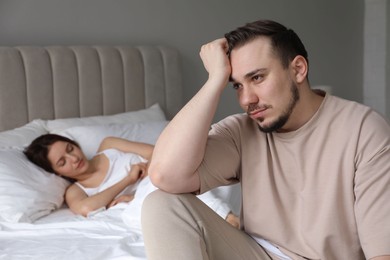 Offended couple after quarrel in bedroom. Relationship problem