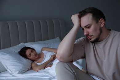 Photo of Offended couple after quarrel in bedroom. Relationship problem