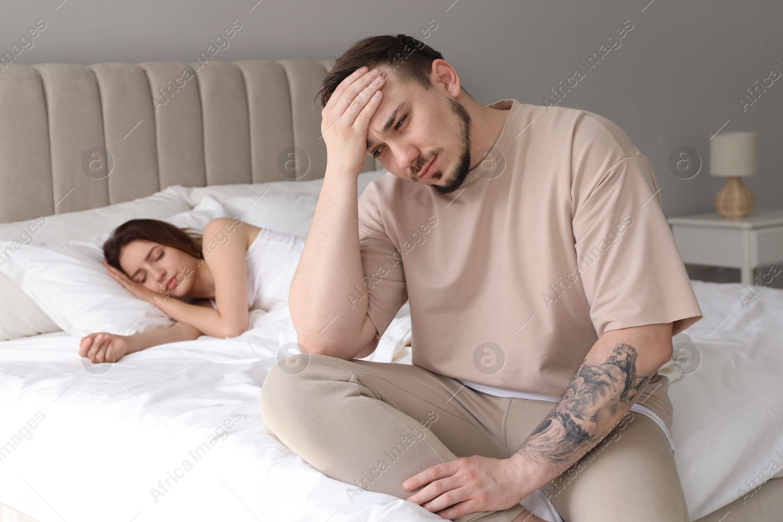 Photo of Offended couple after quarrel in bedroom. Relationship problem