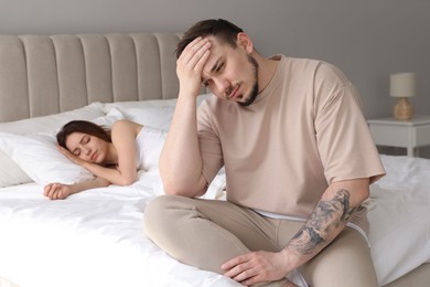 Offended couple after quarrel in bedroom. Relationship problem