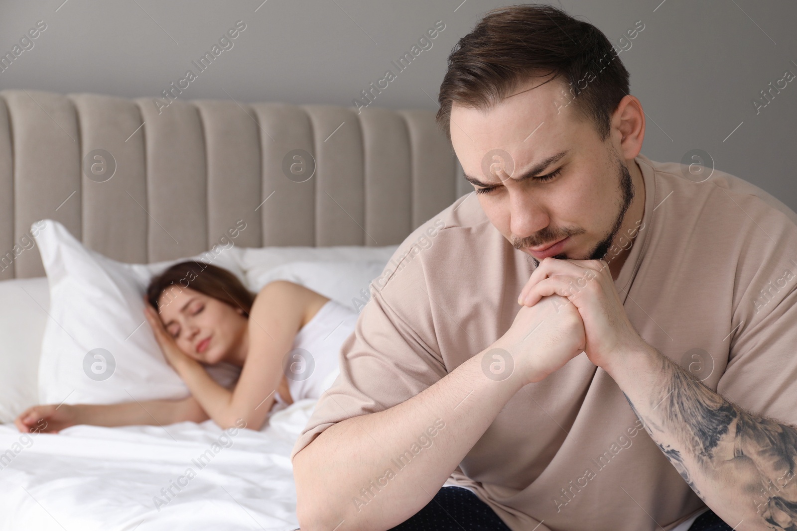 Photo of Offended couple after quarrel in bedroom. Relationship problem