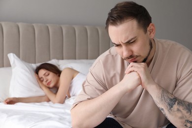 Offended couple after quarrel in bedroom. Relationship problem