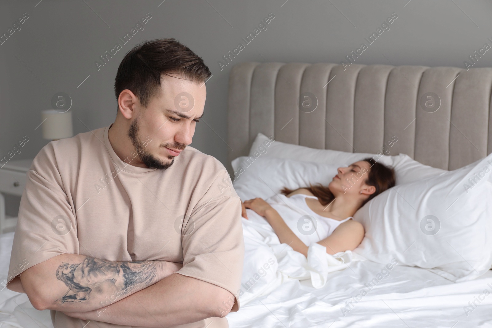 Photo of Offended couple after quarrel in bedroom. Relationship problem