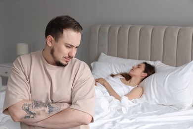 Offended couple after quarrel in bedroom. Relationship problem