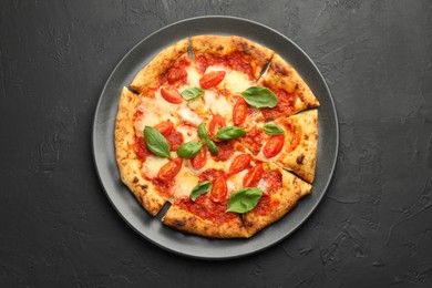 Photo of Delicious Margherita pizza on black table, top view