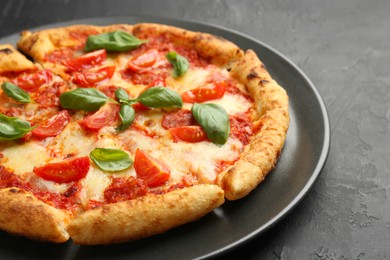 Photo of Delicious Margherita pizza on black table, closeup