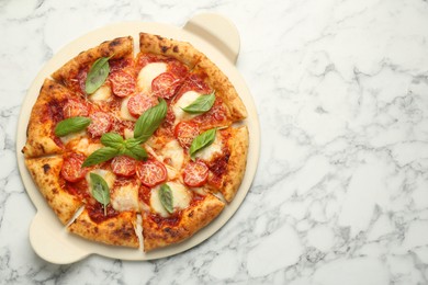 Photo of Delicious Margherita pizza on white marble table, top view. Space for text