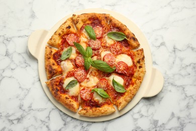 Photo of Delicious Margherita pizza on white marble table, top view