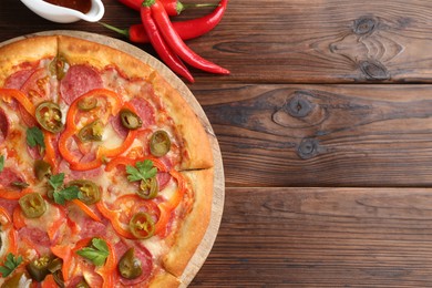 Delicious pizza Diablo served on wooden table, flat lay. Space for text