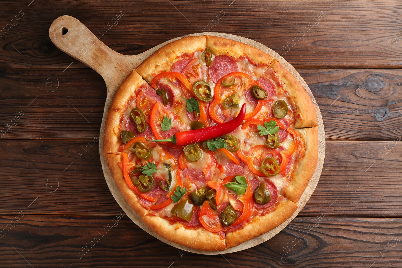 Photo of Delicious pizza Diablo on wooden table, top view