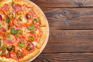 Photo of Delicious pizza Diablo on wooden table, top view. Space for text