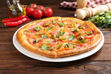 Photo of Delicious pizza Diablo and ingredients on wooden table