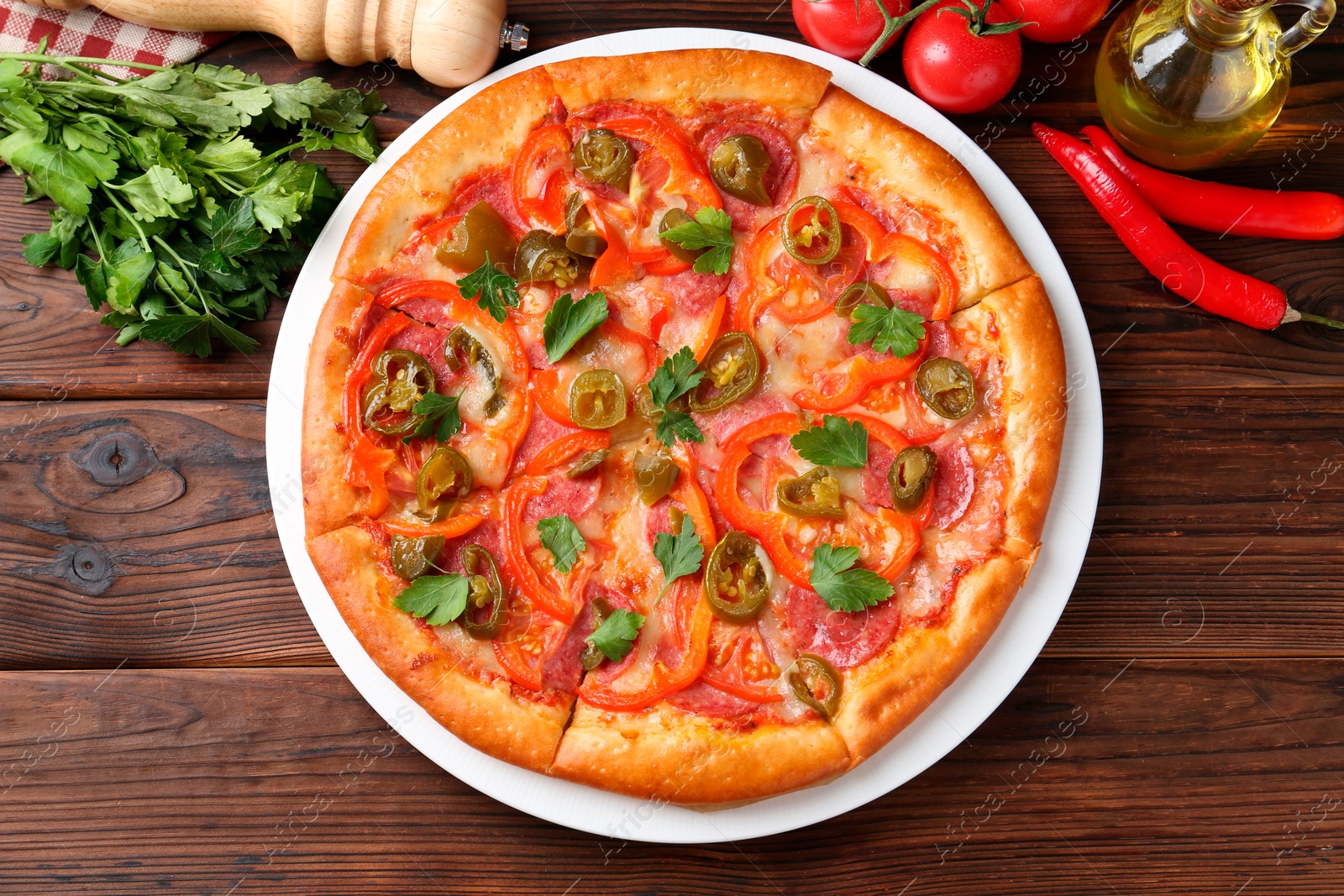 Photo of Delicious pizza Diablo and ingredients on wooden table, flat lay