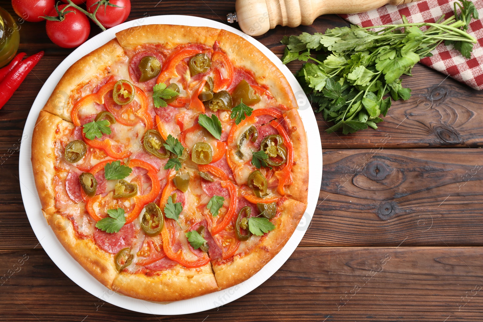 Photo of Delicious pizza Diablo and ingredients on wooden table, flat lay. Space for text