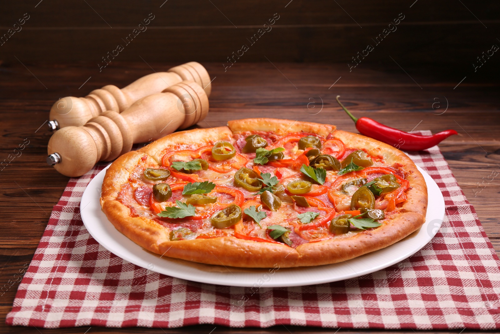 Photo of Delicious hot pizza Diablo on wooden table