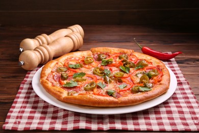 Photo of Delicious hot pizza Diablo on wooden table