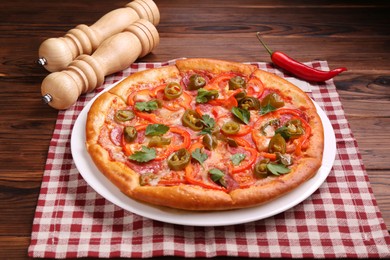 Photo of Delicious hot pizza Diablo on wooden table