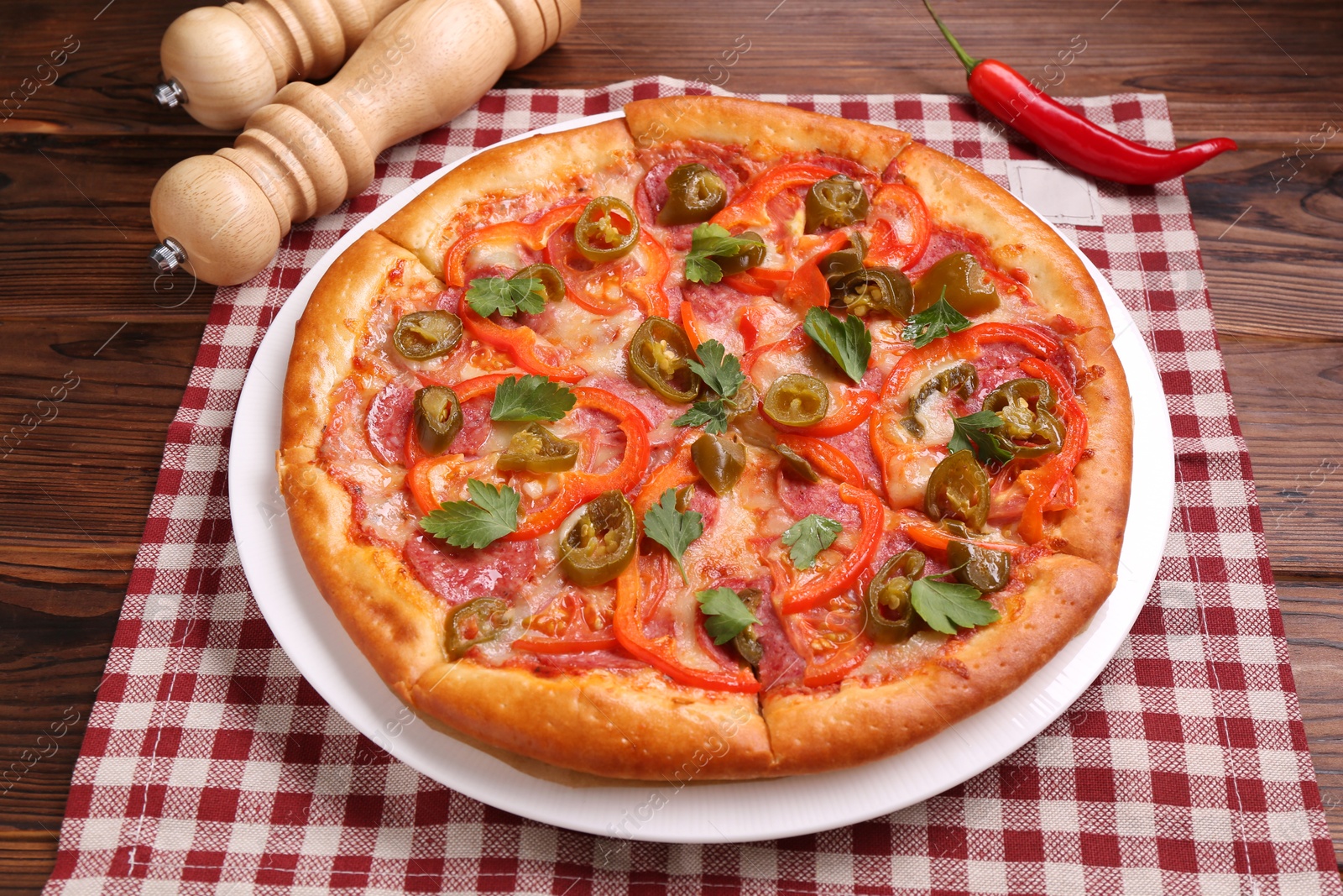 Photo of Delicious hot pizza Diablo on wooden table