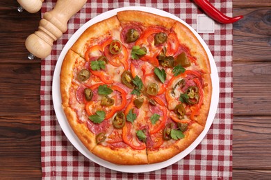 Photo of Delicious hot pizza Diablo on wooden table, top view