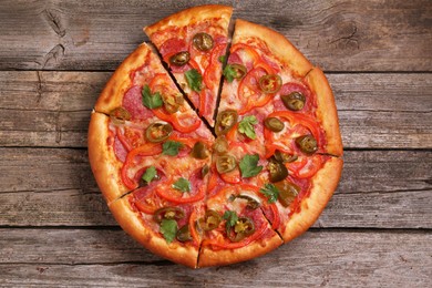 Delicious pizza Diablo on wooden table, top view