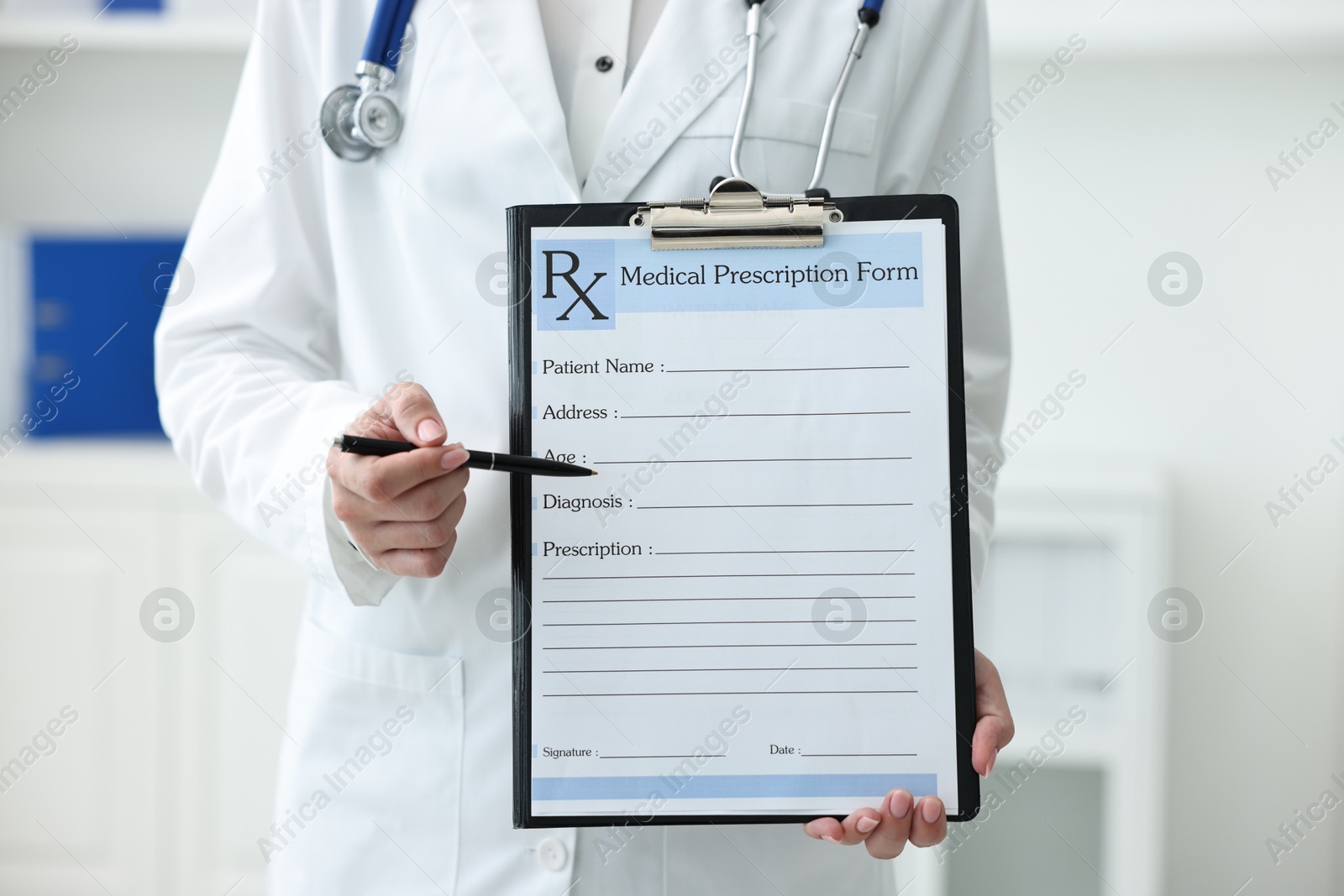 Photo of Doctor with blank prescription form in clinic, closeup