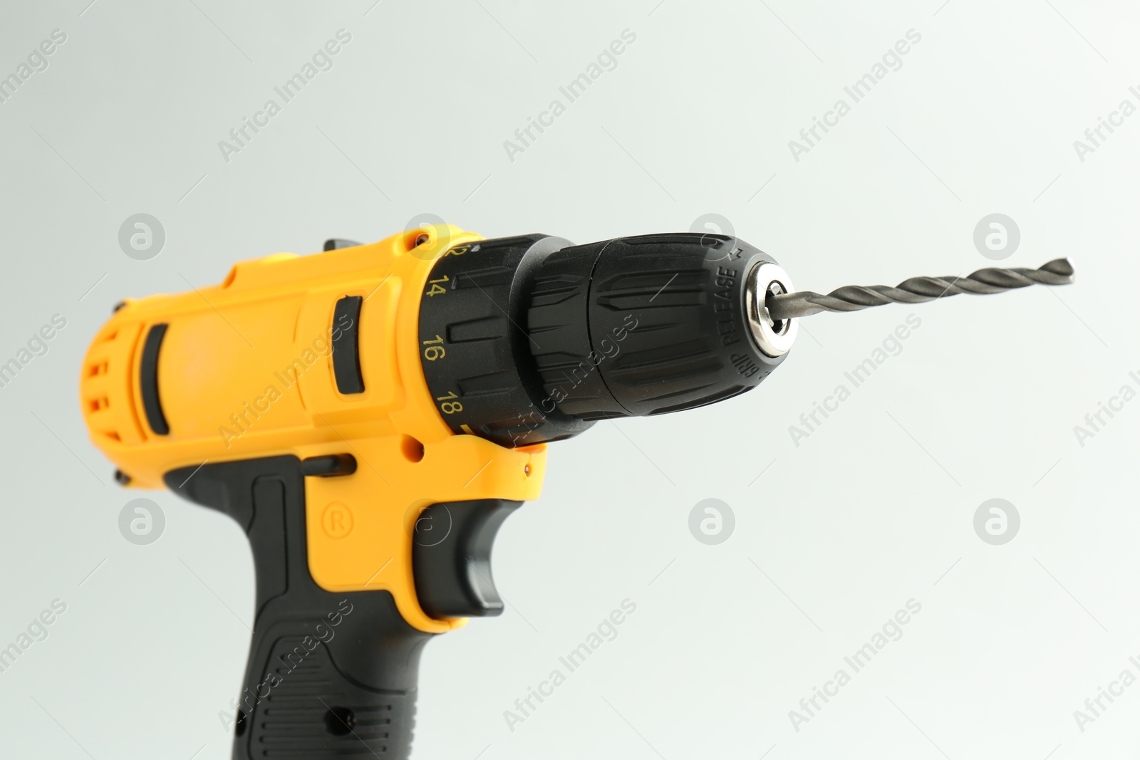 Photo of Modern cordless electric drill on white background, closeup