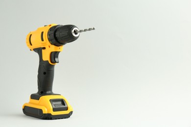 Modern cordless electric drill on white background. Space for text