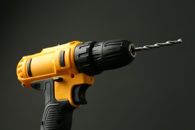 Photo of Modern cordless electric drill on black background