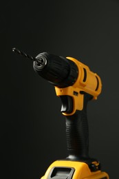 Photo of Modern cordless electric drill on black background