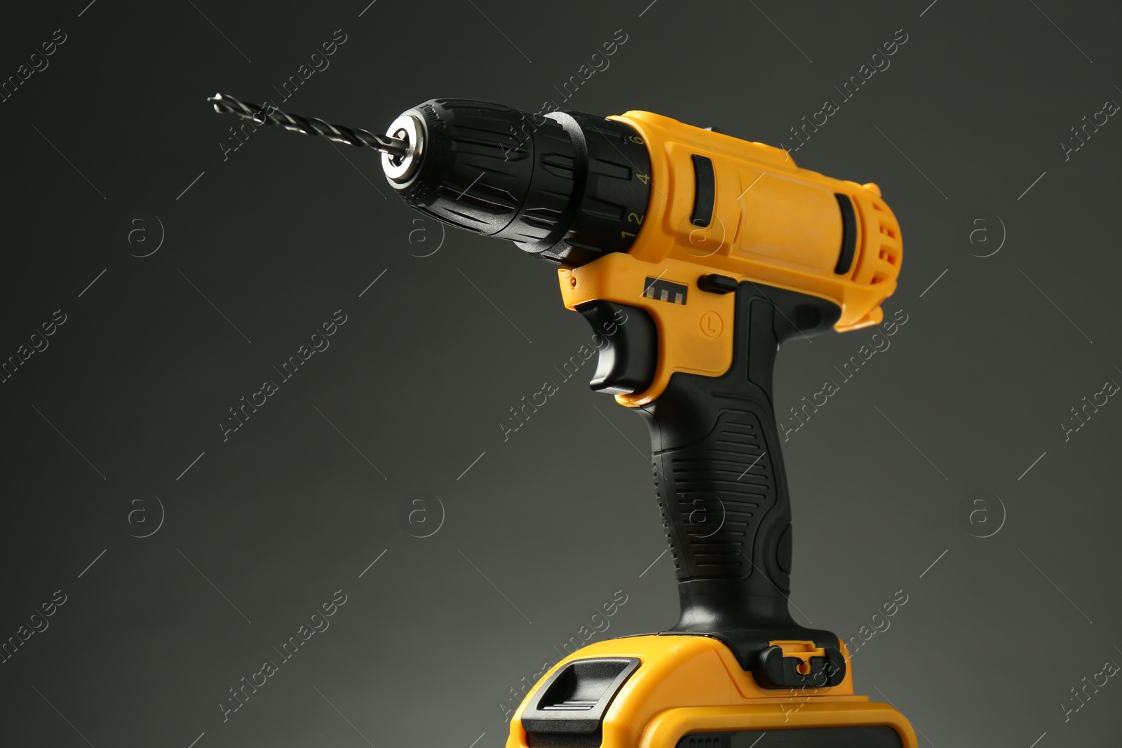 Photo of Modern cordless electric drill on grey background