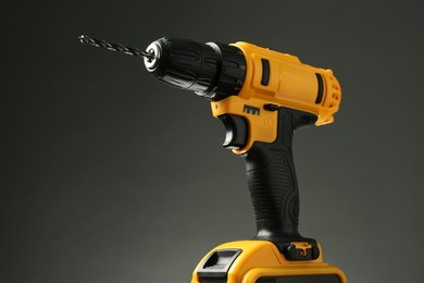 Modern cordless electric drill on grey background