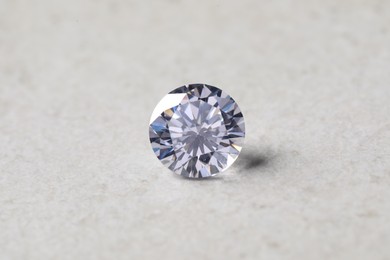 One beautiful shiny diamond on light background, closeup