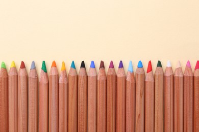 Photo of Equality concept. Different colorful pencils on beige background, top view. Space for text