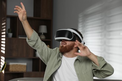 Photo of Man using virtual reality headset at home