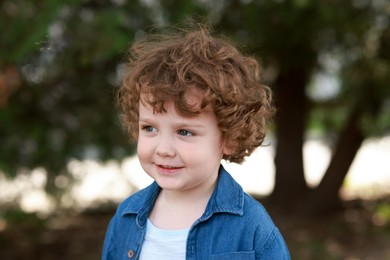 Photo of Portrait of little boy outdoors. Cute child