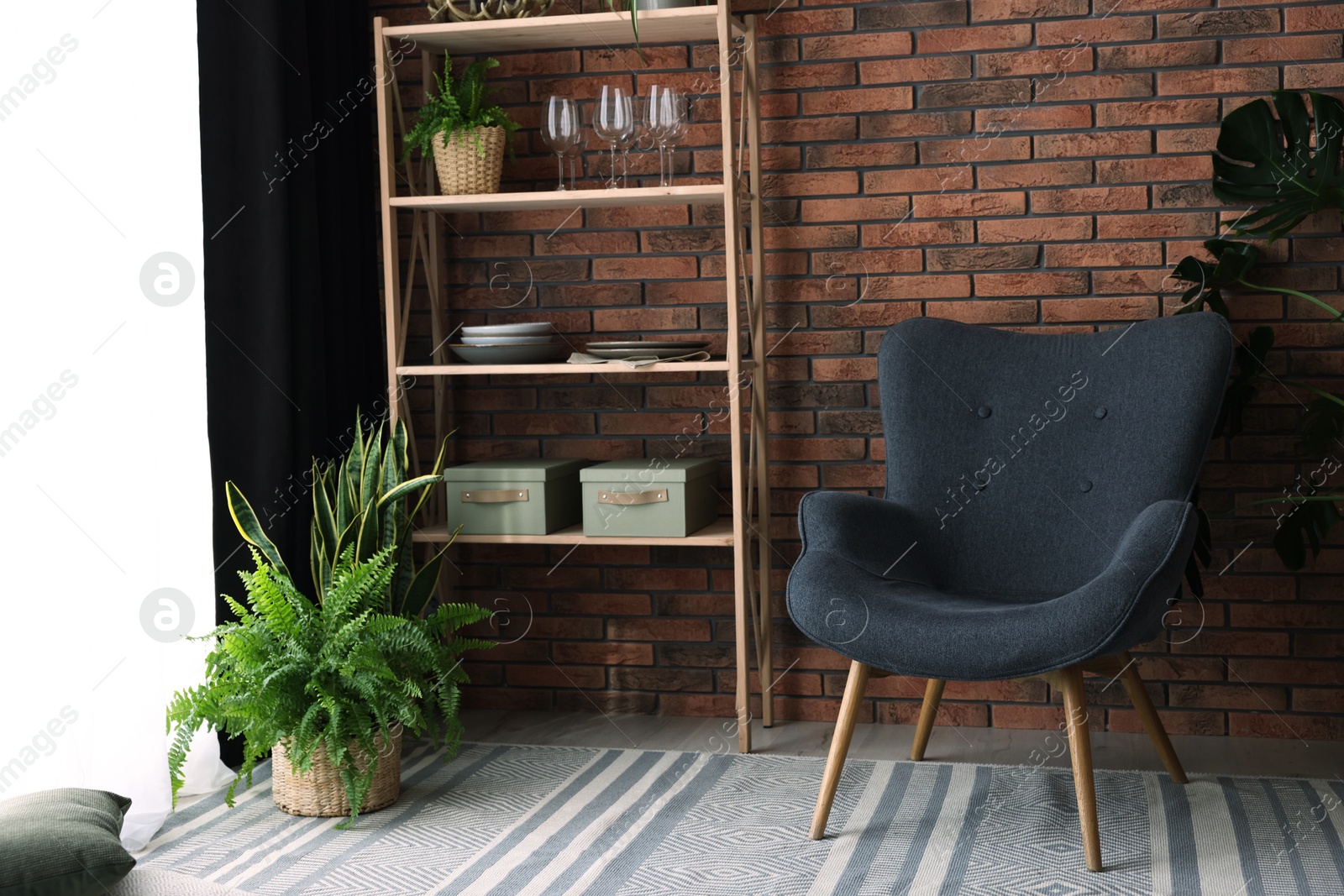 Photo of Shelving unit, green houseplants, armchair and elegant curtain in room. Interior design