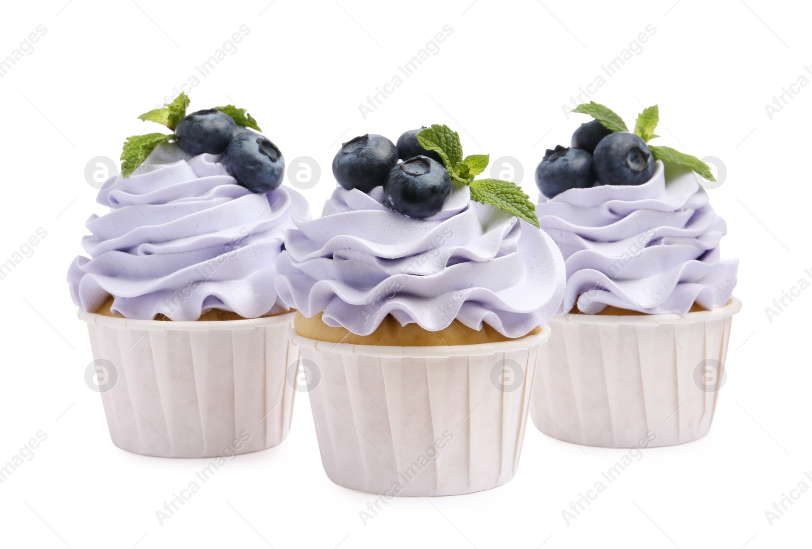 Photo of Tasty cupcakes with blueberries and mint isolated on white