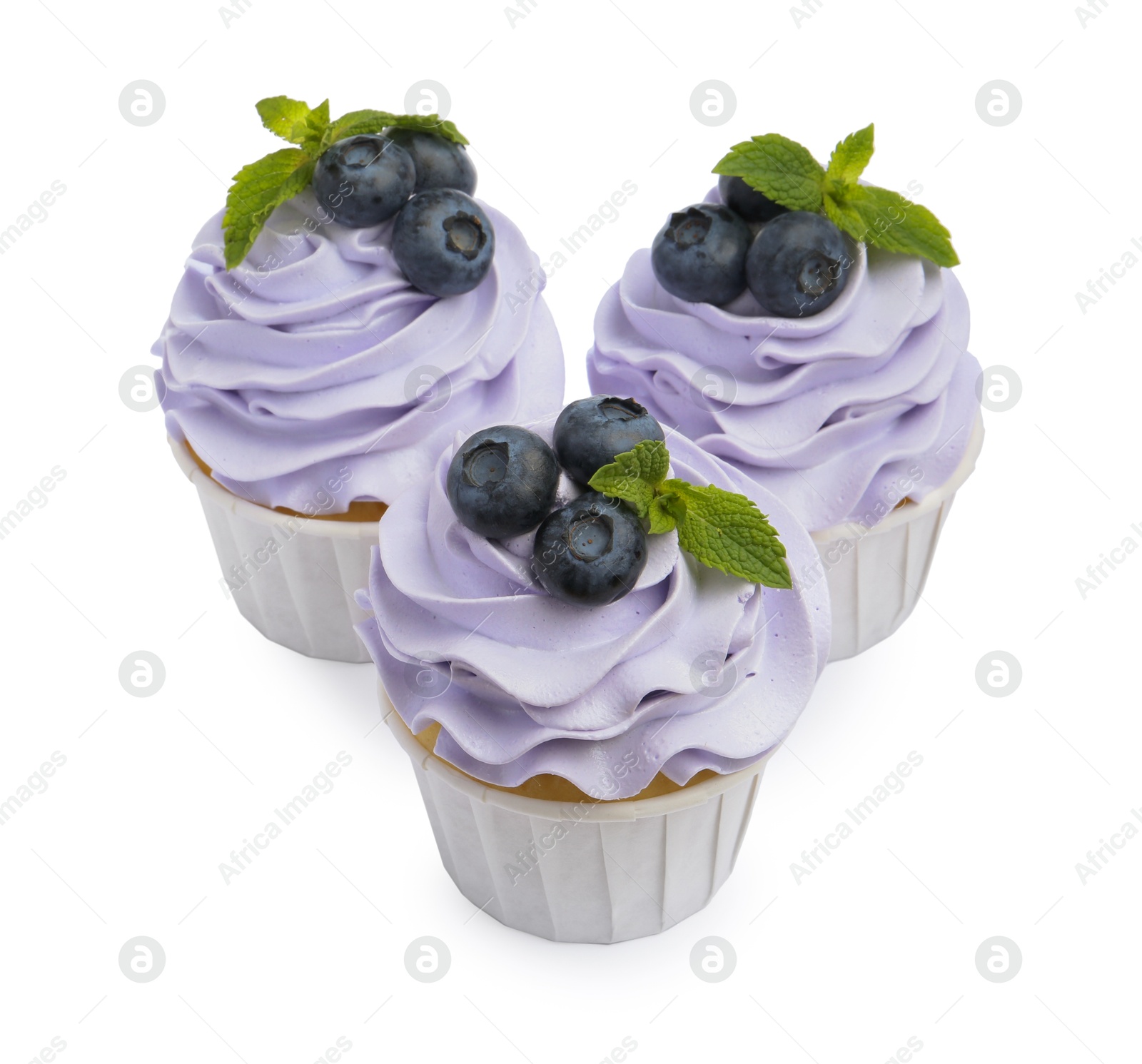 Photo of Tasty cupcakes with blueberries and mint isolated on white