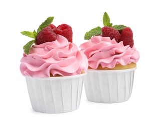 Photo of Tasty cupcakes with raspberries and mint isolated on white