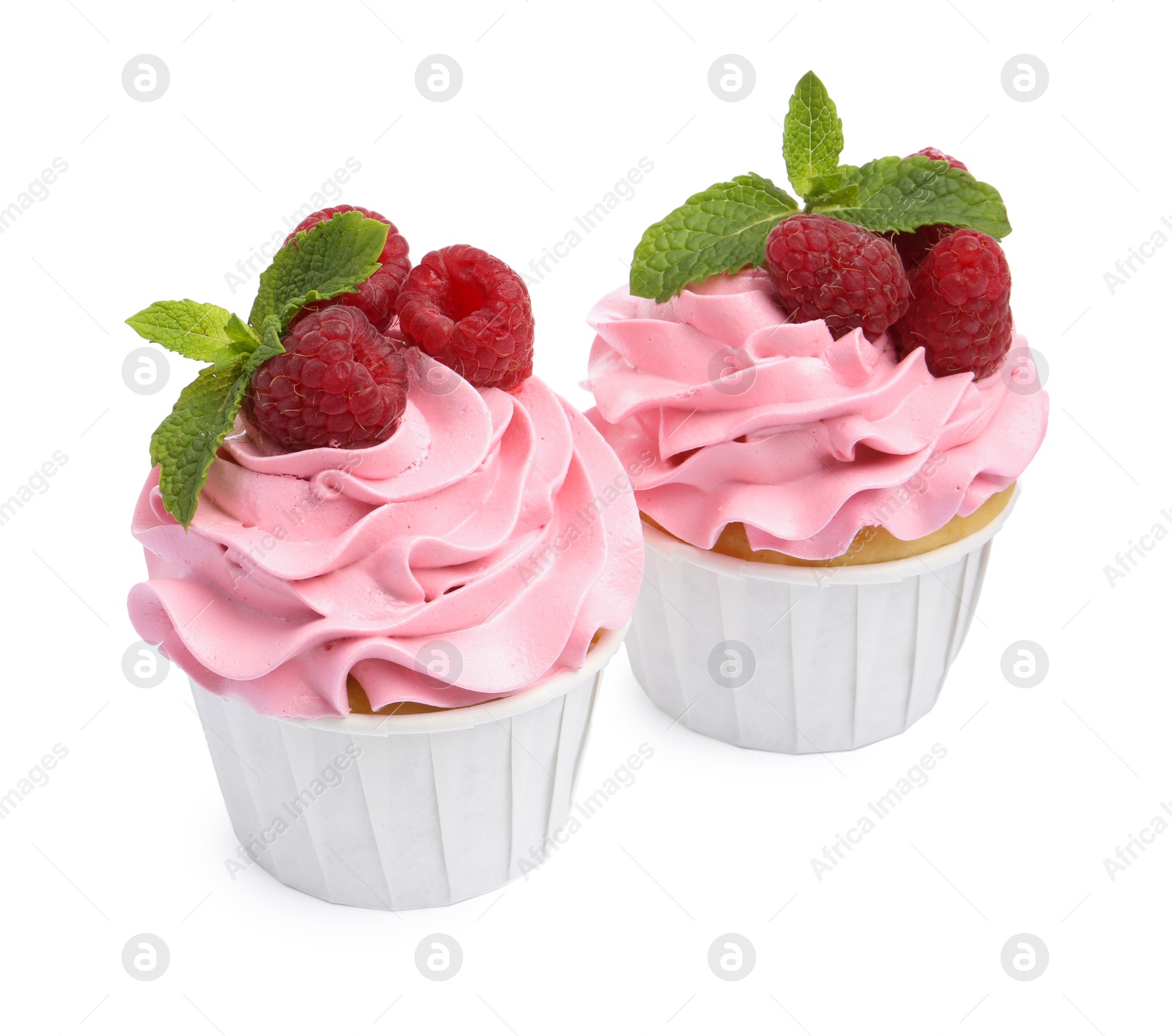 Photo of Tasty cupcakes with raspberries and mint isolated on white